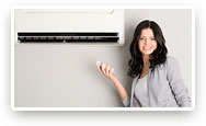 Image of smiling women in front of ductless unit